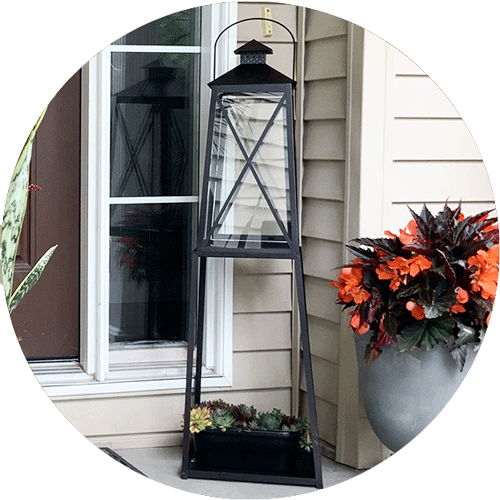A black lantern on a tall black stand.